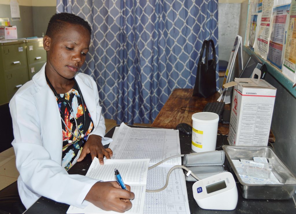 Mourine Andabwa updating patient records at Bukaya Health Center